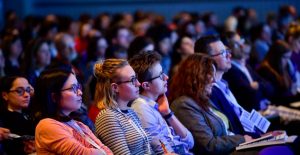 the first row of people at our conference intently looking up at the speaker in front