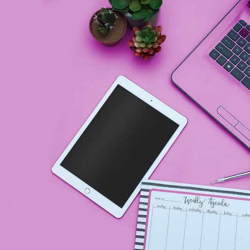 Tablet and laptop on a bright pink background